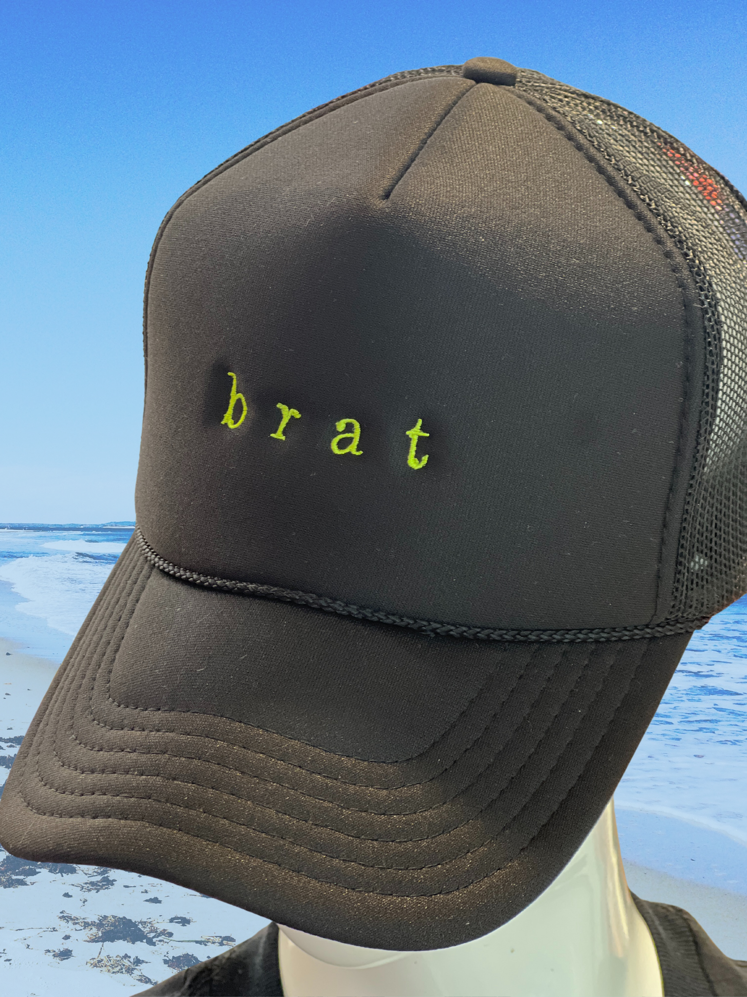 brat...embroidered in neon green on black trucker hat.